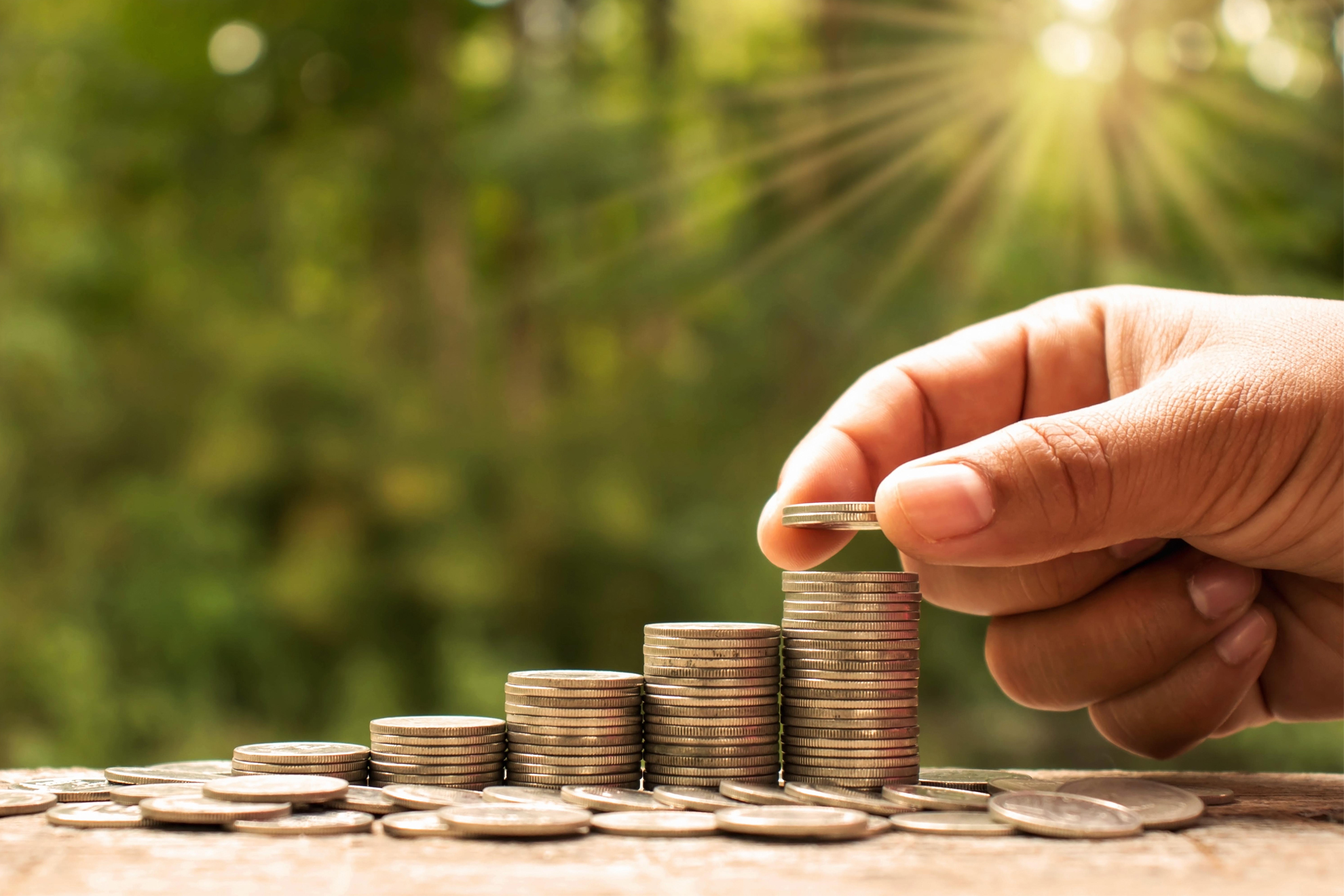 The hands of investors holding coins placed on gold coins at a level different from financial concepts Saving money and investing , CD , cd rates