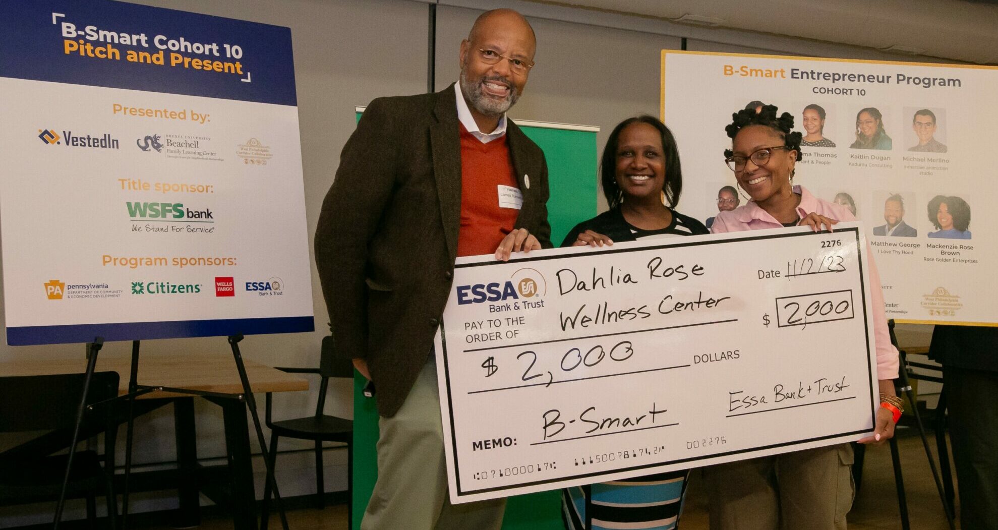 Woman receives check from Pitch Competition.