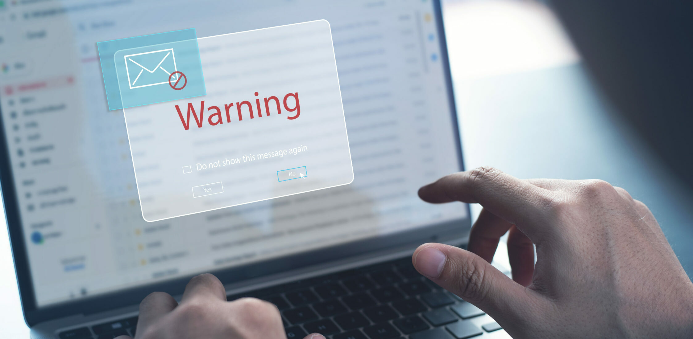 Blocking spam e-mail, warning pop-up for phishing mail, network security concept. Business man working on laptop computer at home with warning window on screen